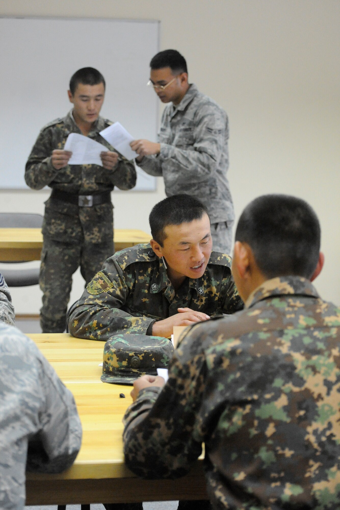 Airman 1st Class Juwin Viray reviews a script with a private from the Koi Tash Noncommissioned Officers Academy, Kyrgyzstan, during a language lab Oct. 6. Juwin is assigned to the 376th Expeditionary Civil Engineer Squadron as an engineering assistant. He is deployed to the Transit Center at Manas from Grand Forks Air Force Base, N.D. (U.S. Air Force photo/Tech. Sgt. Tammie Moore)