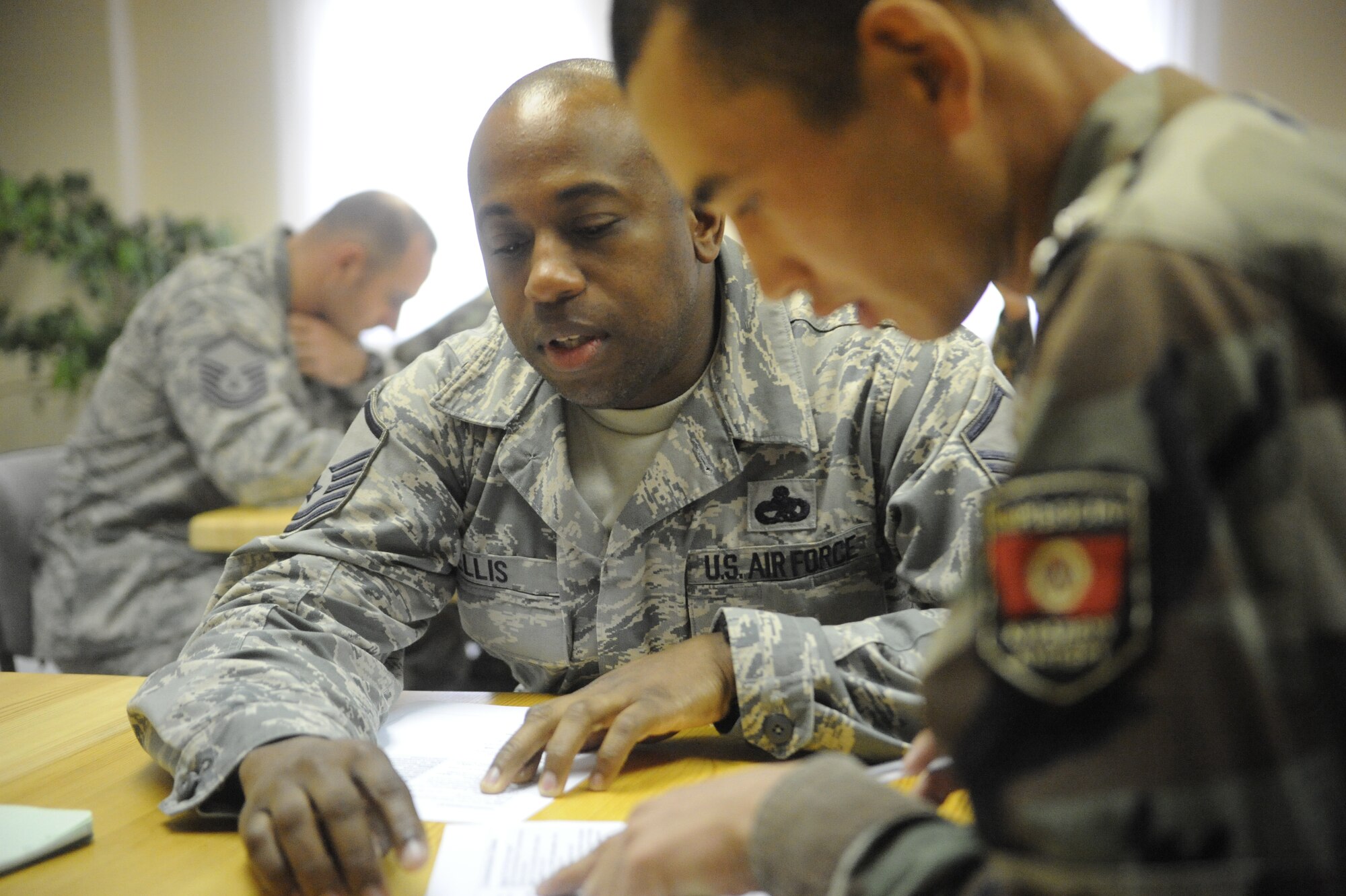 Master Sgt. Chris Ellis reviews the military rank structure with Kyrgyz Republic 2nd Lt. Sheberbec Turdaliev at the Koi Tash Noncommissioned Officers Academy, Kyrgyzstan, during a language lab Oct. 6. Ellis is assigned to the Theater Security Cooperation the Military-to-Military program liaison. He is deployed to the Transit Center at Manas from Dyess Air Force Base, Texas. (U.S. Air Force photo/Tech. Sgt. Tammie Moore)