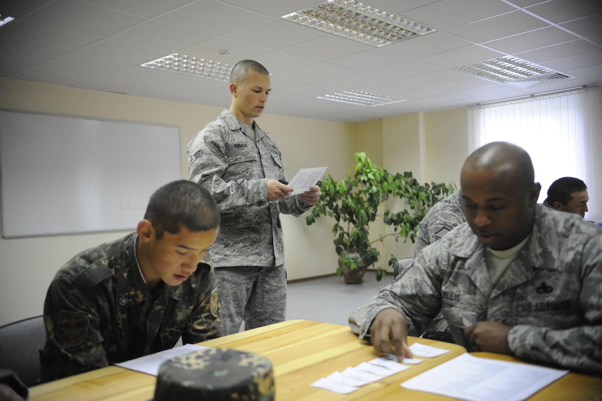 Senior Airman Michael Abrash (standing) reviews vocabulary words during a noncommissioned officer school language exchange at the Koi Tash Noncommissioned Officers Academy, Kyrgyzstan, Oct. 6. Abrash is a Theater Security Cooperation linguist. He is deployed to the Transit Center at Manas from March Air Reserve Base, Calif. (U.S. Air Force photo/Tech. Sgt. Tammie Moore)