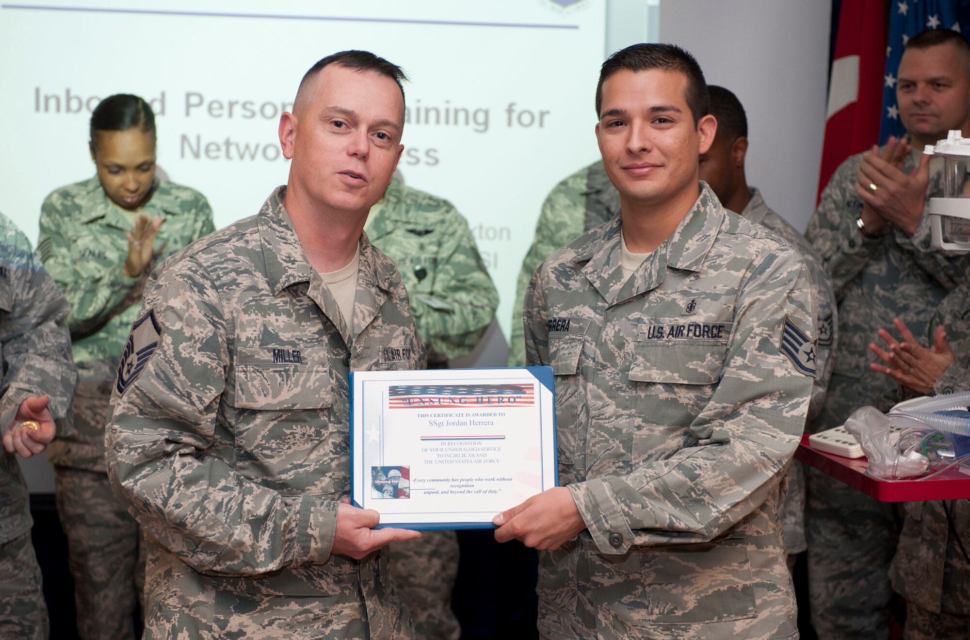 Staff Sgt. Jordan Herrera, 39th Medical Support Squadron biomedical equipment technician, receives the Unsung Hero Award from Incirlik Top 3 members Oct.4, 2011, at Incirlik Air Base, Turkey.  Herrera received the monthly award for leading the staff sergeant release party, completing three college courses with a 3.8 grade point average and responding to 110 job orders as the sole maintenance technician for a two-week period. (U.S. Air Force photo by Senior Airman Clayton Lenhardt/Released)