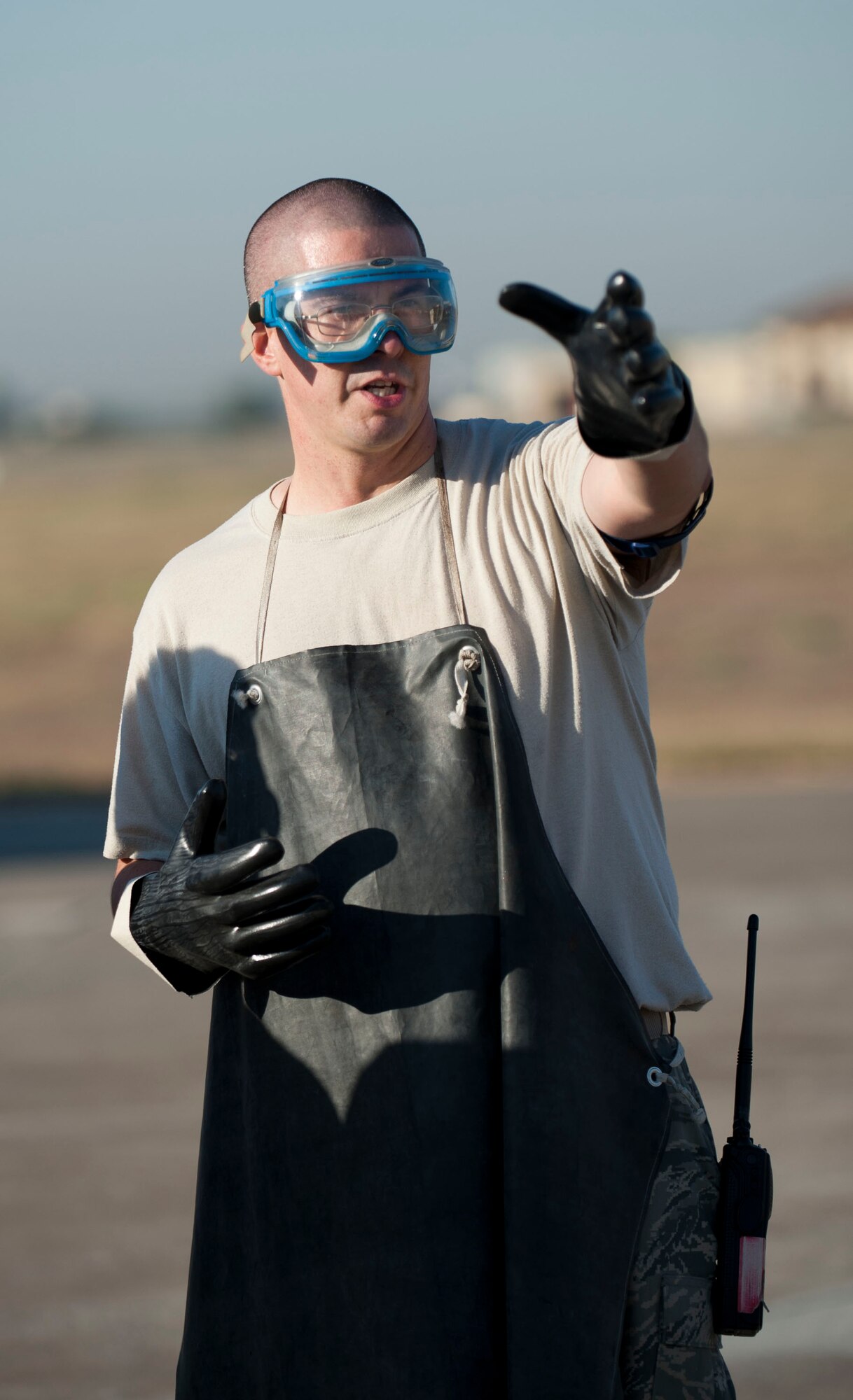 Tech. Sgt. Aaron Gagnon, 39th Logistics Readiness Squadron Petroleum, Oil and Lubricant Flight, describes the extent of a simulated fuel spill to a POL specialist during a fuel spill response exercise Oct. 5, 2011, at Incirlik Air Base, Turkey. POL Airmen are first responders for fuel spills. They stop the source of the leak and place spill pads and boons on the path of the fuel to prevent its spread. (U.S. Air Force photo by Senior Airman Clayton Lenhardt/Released)