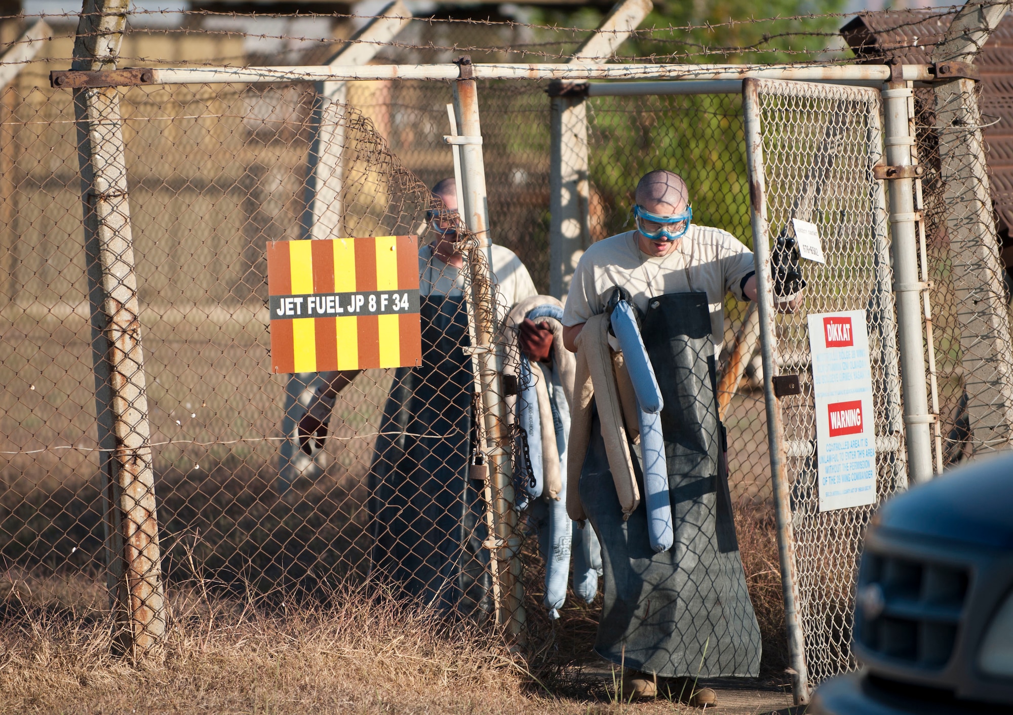 Tech. Sgt. Aaron Gagnon and Staff Sgt. James Woods, both from the 39th Logistics Readiness Squadron Petroleum, Oil and Lubricant Flight, carry oil absorbent material to a simulated fuel spill during a fuel spill response exercise Oct. 5, 2011, at Incirlik Air Base, Turkey. POL Airmen are first responders for fuel spills. They stop the source of the leak and place spill pads and boons on the path of the fuel to prevent its spread. (U.S. Air Force photo by Senior Airman Clayton Lenhardt/Released)