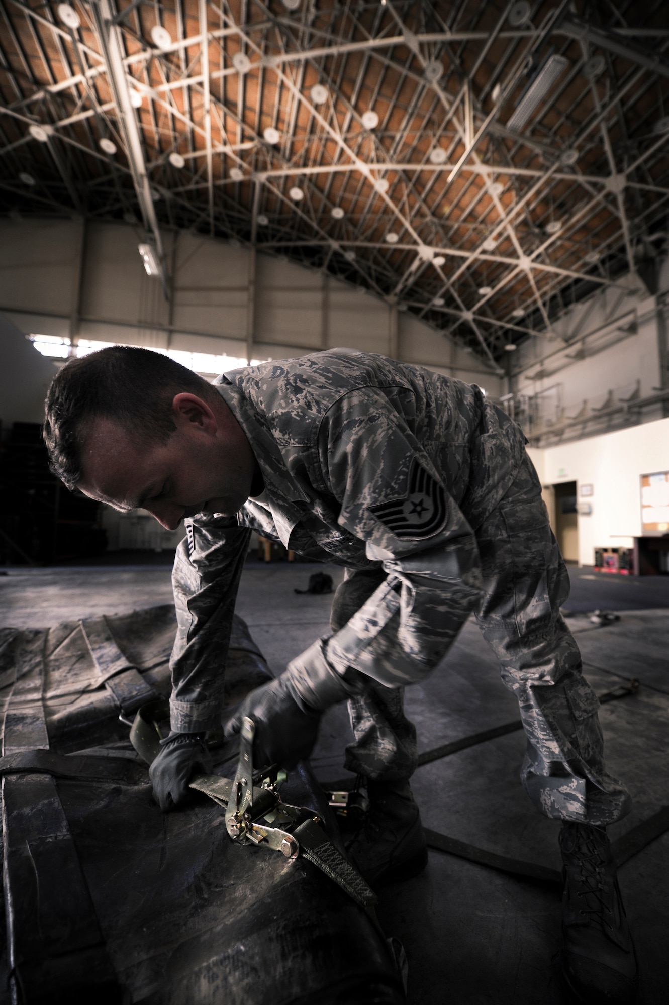YOKOTA AIR BASE, Japan -- Technical Sgt. Keith Sutton, 374th Logistics Readiness Squadron fuels mobility support supervisor, palletizes a 3,000-gallon bladder for an aerial bulk fuel delivery system kit, at Yokota Air Base, Japan, Sept. 28, 2011. Sutton took the bladder off to conduct an annual required inspection, then strapped it back onto the pallet for transport. (U.S. Photo/Staff Sgt Stacy Moless)