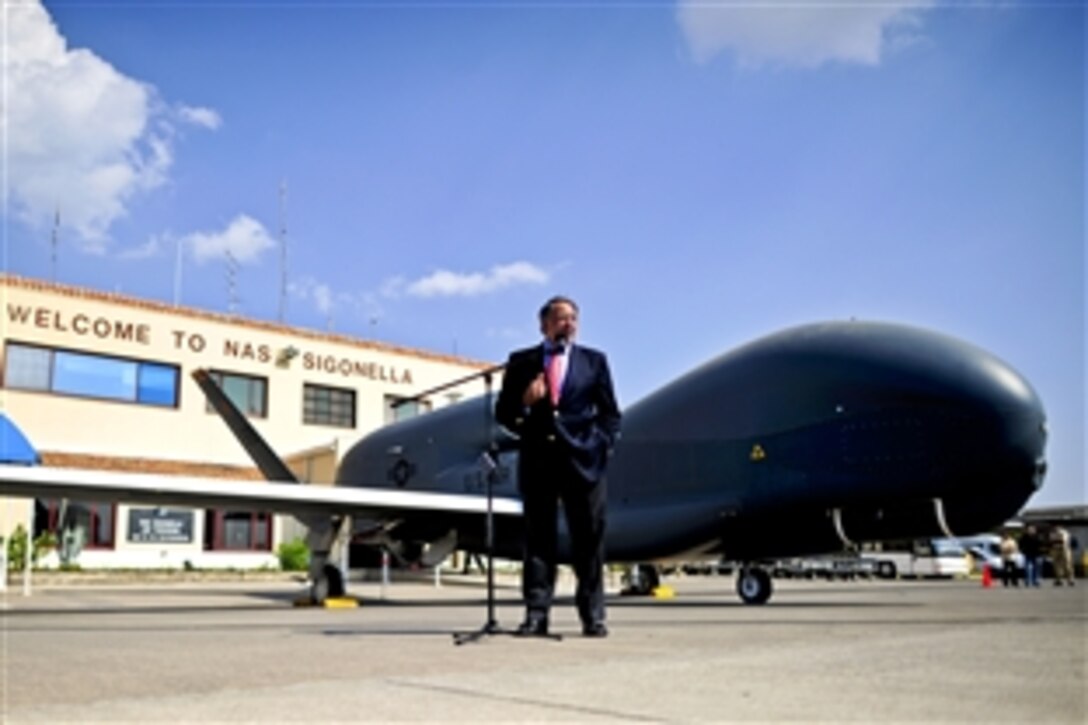 U.S. Defense Secretary Leon E. Panetta stands in front of a RQ-4 Global Hawk as he thanks U.S. and international troops for their service on Naval Air Station Sigonella, Italy, Oct. 7, 2011.