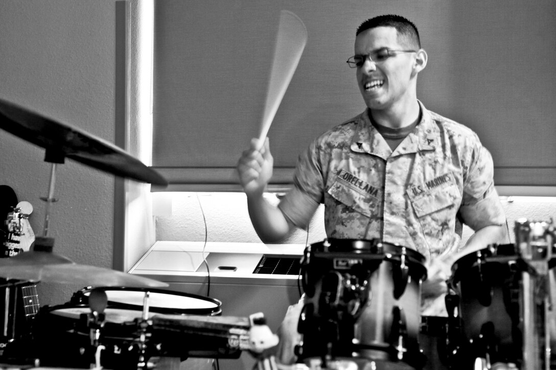 Lance Cpl. Richard B. Orellana, administrative clerk, operations section, 15th Marine Expeditionary Unit, plays his drums in his barracks room in his off time. He started playing the drums at the age of five, and his love for music is what originally led him to join the Marine Corps.  (U.S. Marine Corps photo by Cpl. John Robbart III)