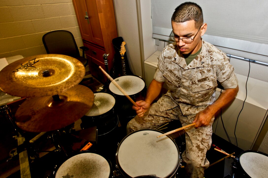 Lance Cpl. Richard B. Orellana, administrative clerk, operations section, 15th Marine Expeditionary Unit, plays his drums in his barracks room in his off time. He started playing the drums at the age of five, and his love for music is what originally led him to join the Marine Corps.  (U.S. Marine Corps photo by Cpl. John Robbart III)