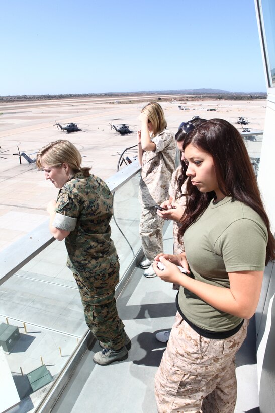 Headquarters and Headquarters Squadron spouses get a view from the top of the air traffic control tower during the 2011 H&HS Jane Wayne Day aboard Marine Corps Air Station Miramar, Calif., Oct. 7. In addition to touring the ATC tower, the participants shot weapons at the Indoor Simulated Marksmanship Trainer and put out a simulated fire with Aircraft Rescue and Fire Fighting.::r::::n:: ::r::::n::