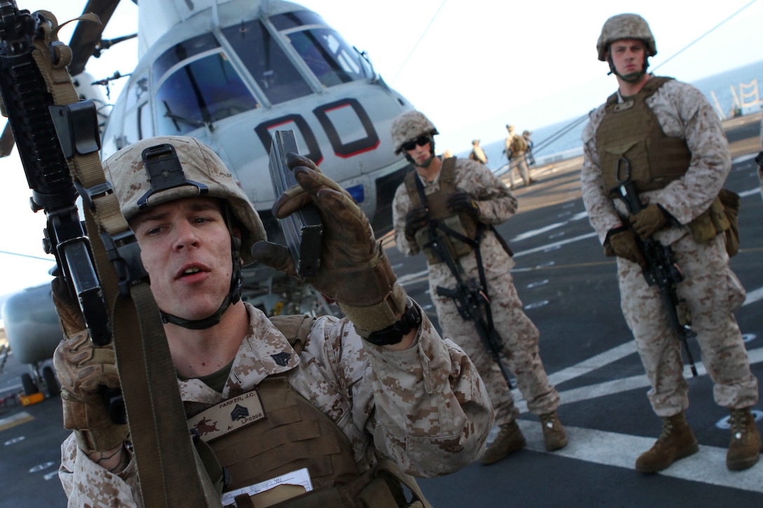Sgt. Jonathan Parker instructs Marines how to tactically reload a rifle aboard the amphibious transport dock New Orleans Oct. 7 during the 11th Marine Expeditionary Unit's final exercise before deploying in November. Parker is a 24-year-old Lake Havasu, Ariz., native and a squad leader with Company L. The company is one of three rifle companies with Battalion Landing Team 3/1, the ground combat element for the unit.