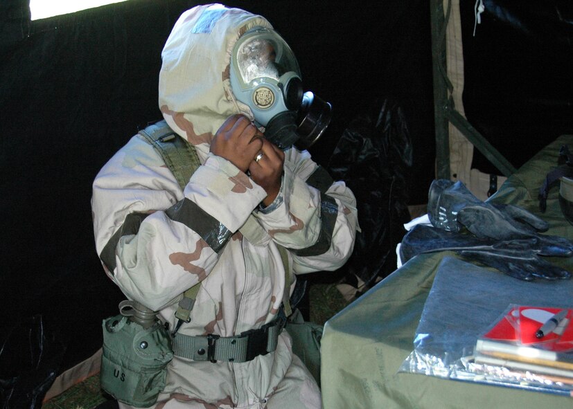 Air Force Reserve Senior Airman Lakeeg Bryant of the 919th Force Support Squadron removes his gas mask following a recent chemical warfare defense scenario at Duke Field, Fla.   The simulation was one of several conducted during the 919th Special Operations Wing's Operational Readiness Exercise which tested the reservists' ability to survive and operate after an enemy attack.  (U.S. Air Force photo/Dan Neely)