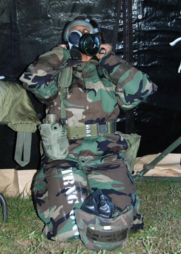 Air Force Reserve Staff Sgt. Eunice Mims of the 919th Force Support Squadron, removes her gas mask following a recent chemical warfare defense scenario at Duke Field, Fla.  The simulation was one of several conducted during the 919th Special Operations Wing's Operational Readiness Exercise which tested the reservists' ability to survive and operate after an enemy attack.  (U.S. Air Force photo/Dan Neely)