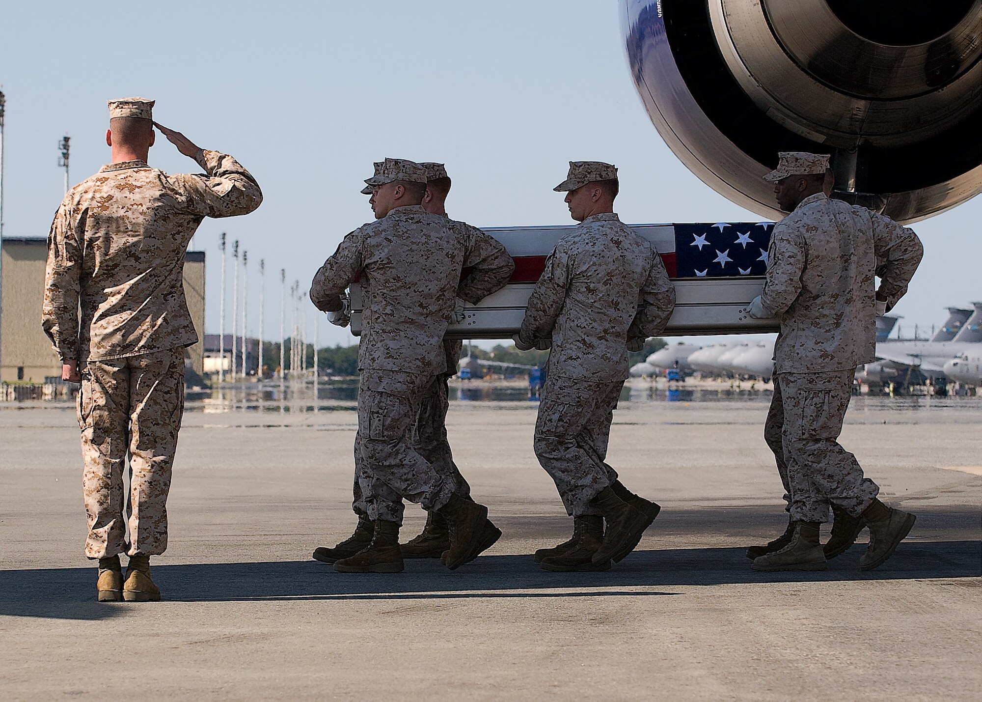 A U.S. Marine Corps carry team transfers the remains of Marine Lance Cpl. Benjamin W. Schmidt, of San Antonio, Texas, at Dover Air Force Base, Del., Oct. 8, 2011. Schmidt was assigned to the 2nd Battalion, 4th Marine Regiment, 1st Marine Division, I Marine Expedtionary Force, Camp Pendleton, Calif.(U.S. Air Force photo/Steve Kotecki)