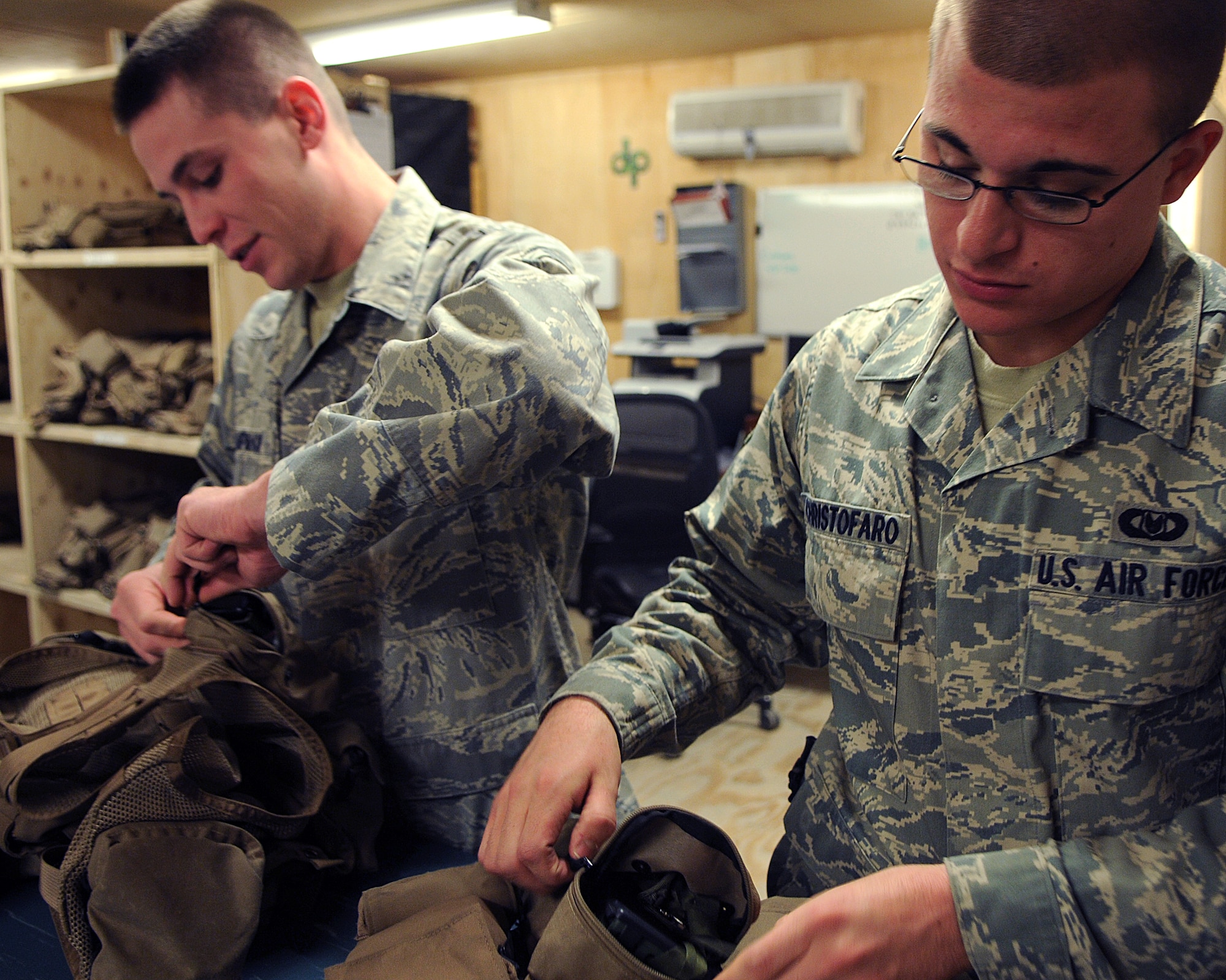 BAGRAM AIRFIELD, Afghanistan -- Senior Airmen James Christofaro and 
Andrew Lampman, both 455th Expeditionary Operations Group life support
Technicians, inspect the serviceability on all items in survival vests here
Sept. 03, 2011. During post flight routine checks, life support ensures
all items are clean, serviceable and accounted for. (U.S. Air Force
photo/Senior Airman Krista Rose)

