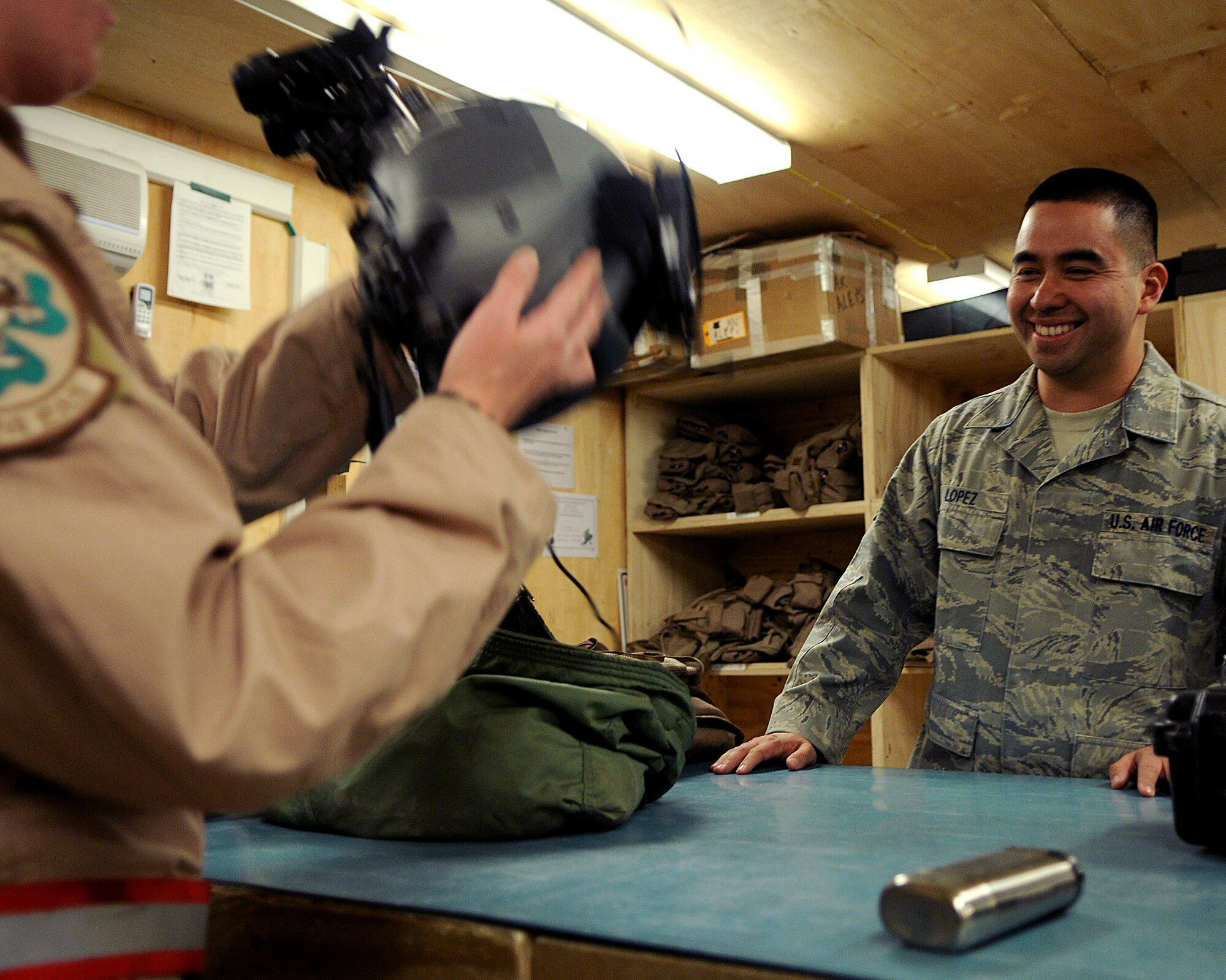 BAGRAM AIRFIELD, Afghanistan -- Staff Sgt. Jonathen Lopez, 455th
Expeditionary Operations Group life support technician, assists a pilot
fitting his helmet during preflight equipment checks here Sept. 03, 2011.
Jonathen is deployed from Channel Islands Air National Guard and is a native
of Oxnard, Calif. (U.S. Air Force photo/Senior Airman Krista Rose)
