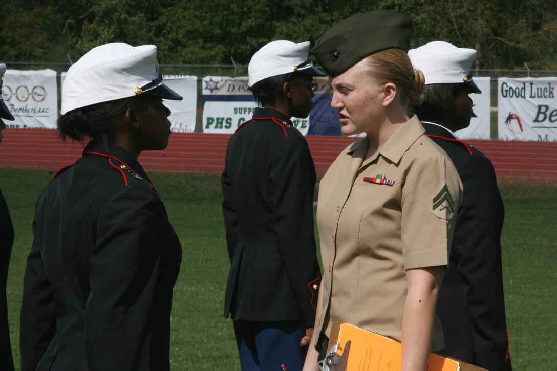 Cpl. Nicole M. Ostrander, defense clerk from the Office of the Staff Judge Advocate, Marine Forces Reserve, tests the cadet here, Oct. 8, 2011, on knowledge of Marine Corp’s customs, courtesies, and history. Some 500 cadets from 15 different schools showed up at the Ponchatoula High School Junior Recruit Officer Training Corps meet to compete against each other in marching, knowledge and physical training.