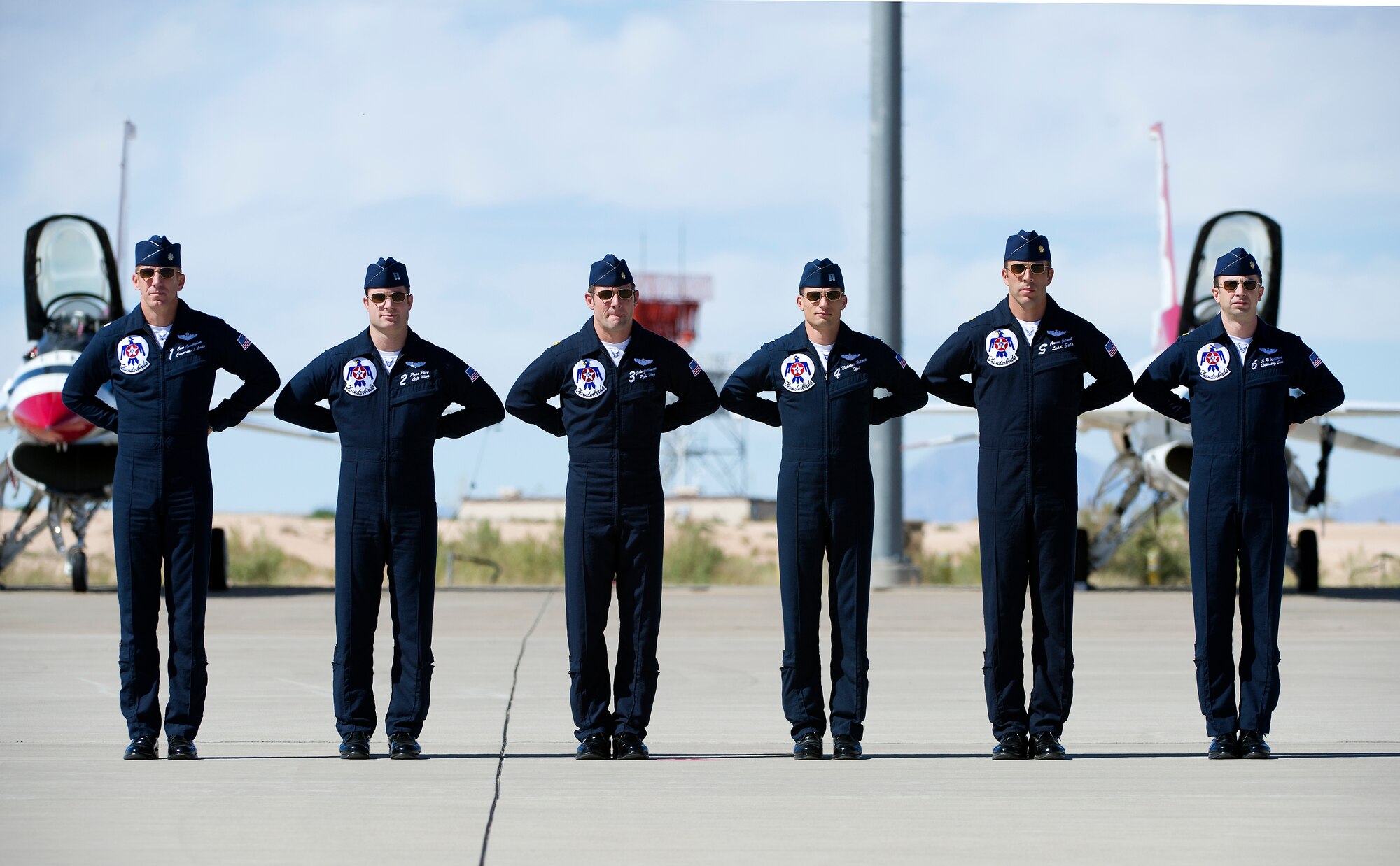 HOLLOMAN AIR FORCE BASE, N.M. -- Members of the U.S. Air Force Thunderbirds demonstration team stand at parade rest Oct. 8, 2011, before beginning their performance at the “Legacy of Liberty” Open House and Air Show. The Thunderbirds were the final performance of the air show. (U.S. Air Force photo by Senior Airman DeAndre Curtiss / Released) 