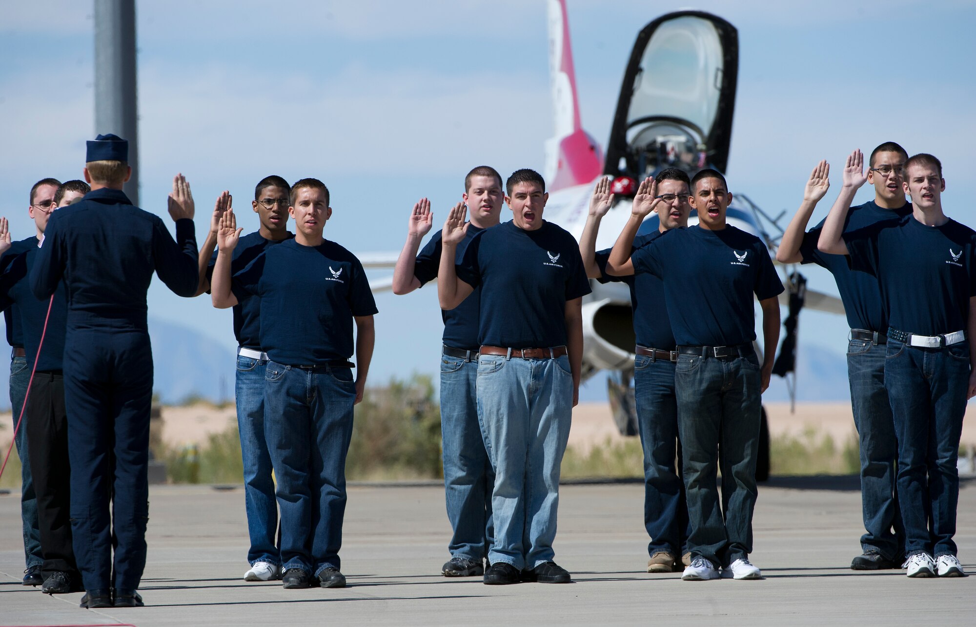HOLLOMAN AIR FORCE BASE, N.M. -- U.S. Air Force Lt. Col. Case Cunningham, Thunderbird 1, administers the oath of enlistment to future USAF trainees Oct. 8, 2011, before the U.S. Air Force Thunderbirds aerial demonstration at the “Legacy of Liberty” Open House and Air Show. The Thunderbirds often swear in soon-to-be recruits at the air shows where they perform. (U.S. Air Force photo by Senior Airman DeAndre Curtiss / Released) 