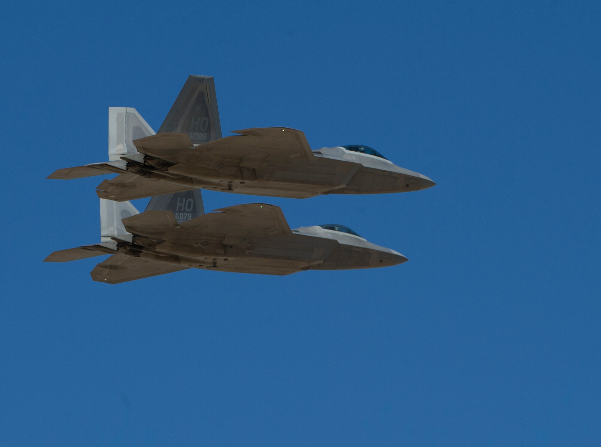 HOLLOMAN AIR FORCE BASE, N.M. -- Two F-22 Raptors perform a fly-by after the playing of Taps Oct. 8, 2011, to recognize all fallen service members during the “Legacy of Liberty” Open House and Air Show. The F-22 Raptor is the Air Force’s newest fighter aircraft and its combination of stealth, super cruise and maneuverability represents a leap in technology. (U.S. Air Force photo by Senior Airman DeAndre Curtiss/Released) 