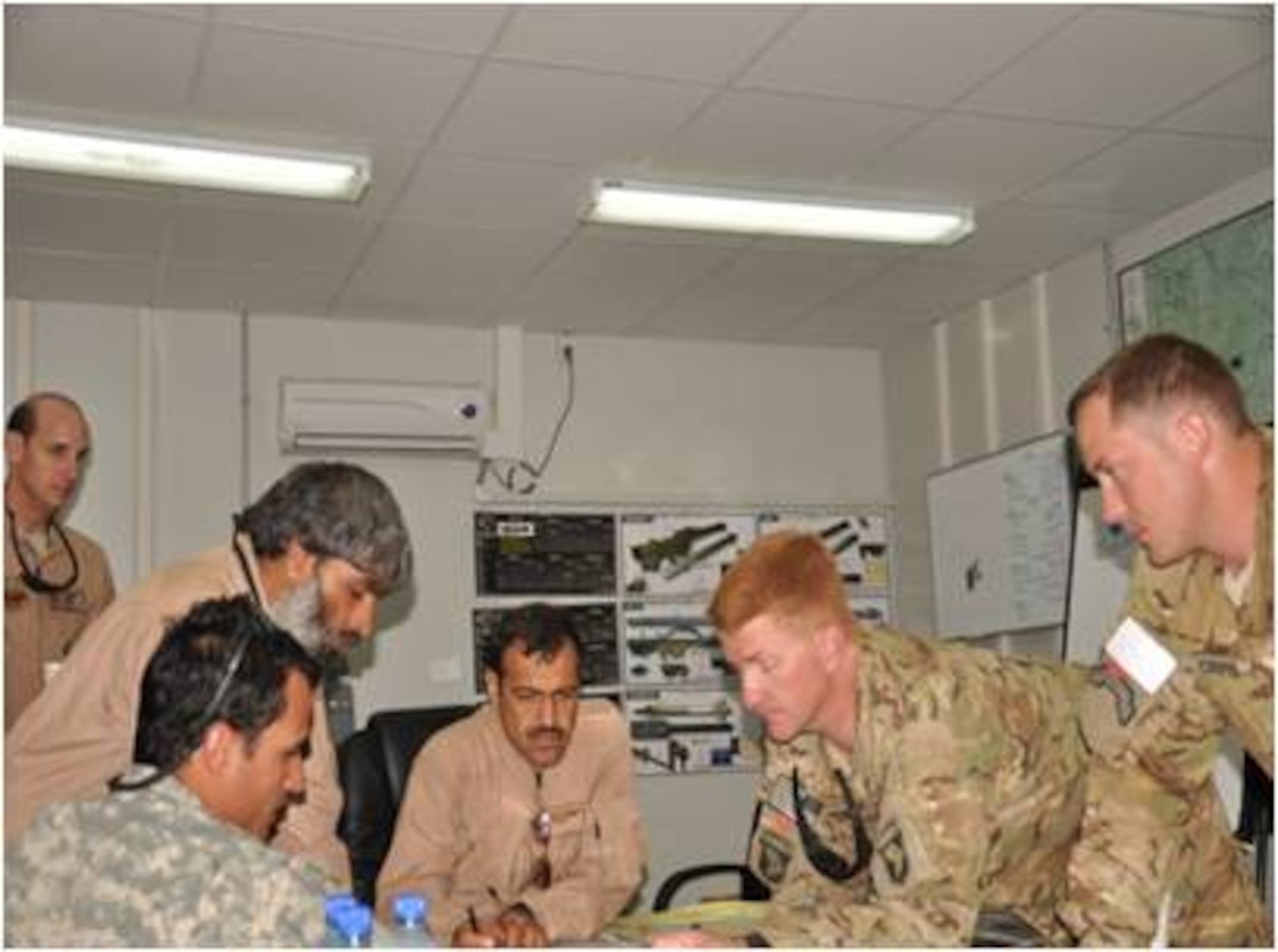 Task Force Thunder aircrew worked together with Afghan Air Force members to plan Operation Sand Hill Crane at Kandahar Air Wing recently. Officials explained the mission's goal was to insert specialized teams into strategic locations where reintegration leaflets would target Taliban fighters making their way out of Kandahar province. The mission was supported by Task Force Thunder OH-58D and AH-64 helicopters as well as two UH-60 Blackhawks and an Afghan Air Force Mi-17 helicopter. (U.S. Air Force courtesy photo)