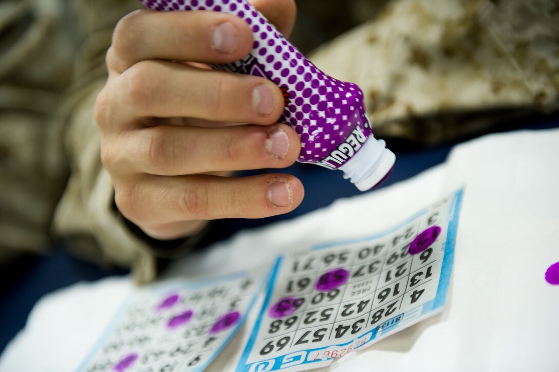 A Marine with the 11th Marine Expeditionary Unit marks numbers on a bingo card aboard USS Makin Island here Oct. 9. The 11th Marine Expeditionary Unit embarked USS Makin Island, USS New Orleans and USS Pearl Harbor in San Diego Sept. 28 and is participating in its final exercise before deploying in November.