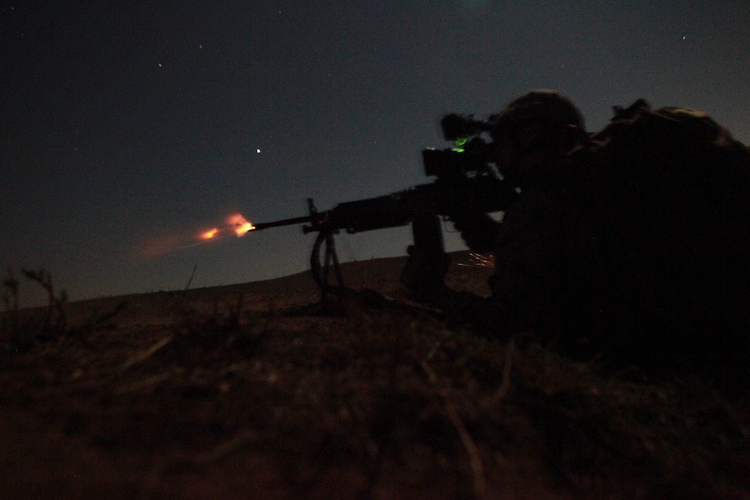 Lance Cpl. Kyle Turner, a medium machine gunner with the 11th Marine Expeditionary Unit's maritime raid force, fires at targets during a live-fire exercise here Oct. 9. Turner, 18, is from St. Louis. The unit embarked USS Makin Island, USS New Orleans and USS Pearl Harbor in San Diego Sept. 28 and is participating in its final exercise before deploying in November.