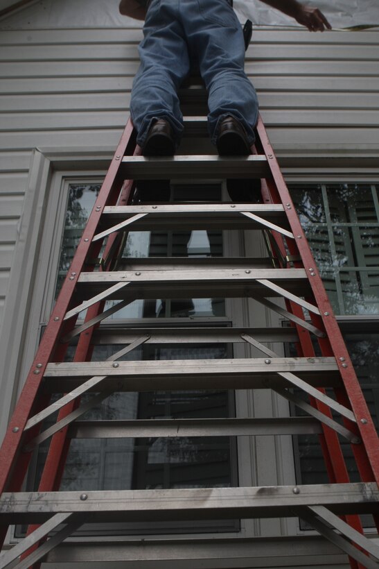 A volunteer nails vinyl siding into the house of Eric and Cheryl LeClair’s house during the Military Missions In Action build in Swansboro, N.C., Oct. 10. The LeClair’s house, in serious need of repair, was refurbished by volunteers from MMIA, Home Depot and Wellness for Warriors.