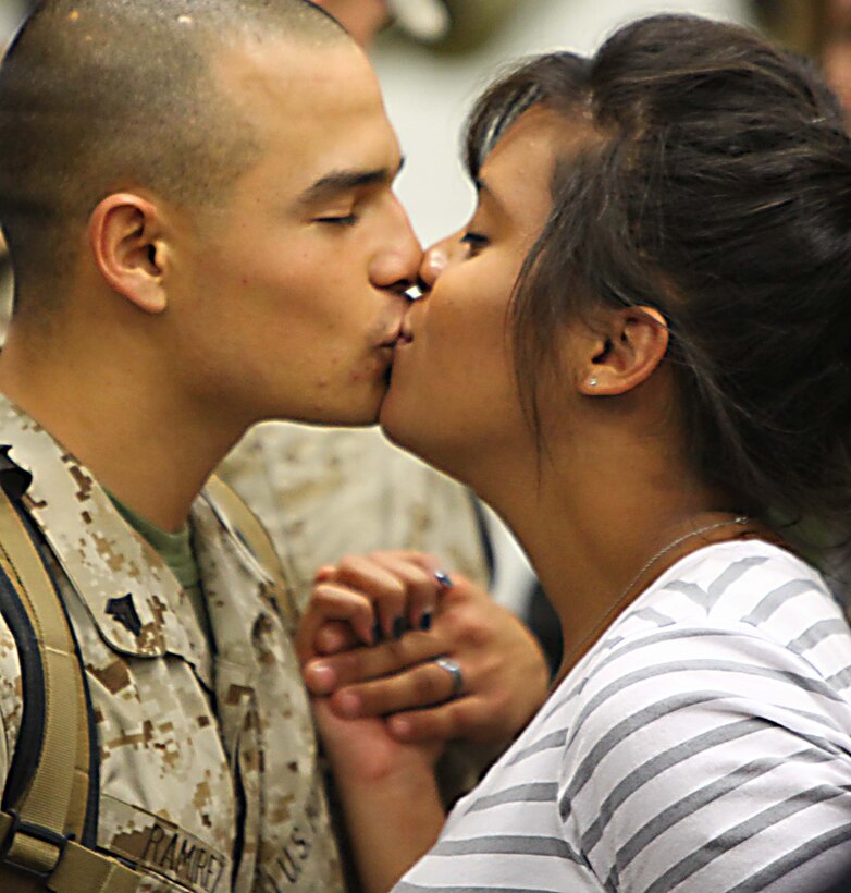 A Marine with 2nd Maintenance Battalion, 2nd Marine Logistics Group kisses his wife during a homecoming Oct. 14, 2011, aboard Marine Corps Base Camp Lejeune, N.C. Family members, friends, Marines and sailors recently gathered for the event to welcome the unit back from their six-month tour in Helmand Province, Afghanistan. (Photo by Cpl. Andrew D. Johnston)