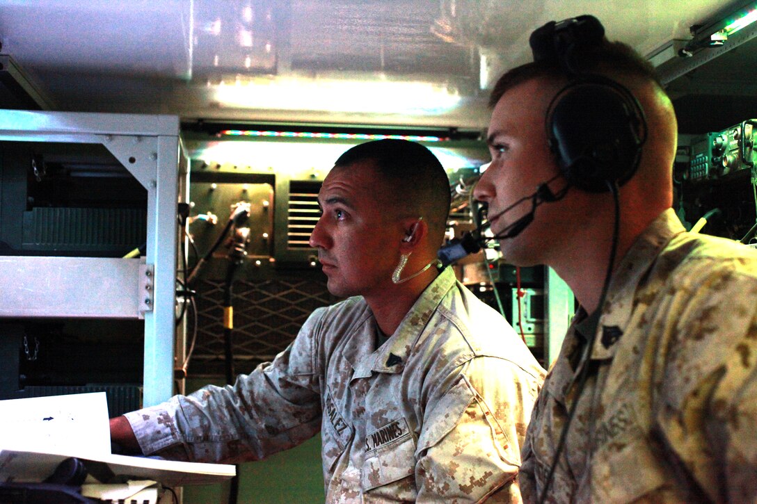Cpl. Joseph L. Rosalez, left, a native of Ganado, Texas, and Sgt. Jordan M. Hendrix, from Indianapolis, Ind., monitor communications for 2nd Marine Aircraft Wing (Forward)’s direct air support center from a truck at Camp Leatherneck, Afghanistan, Oct. 10. Rosalez serves as an avionics communications systems technician and Hendrix is a tactical data network administrator with the center.