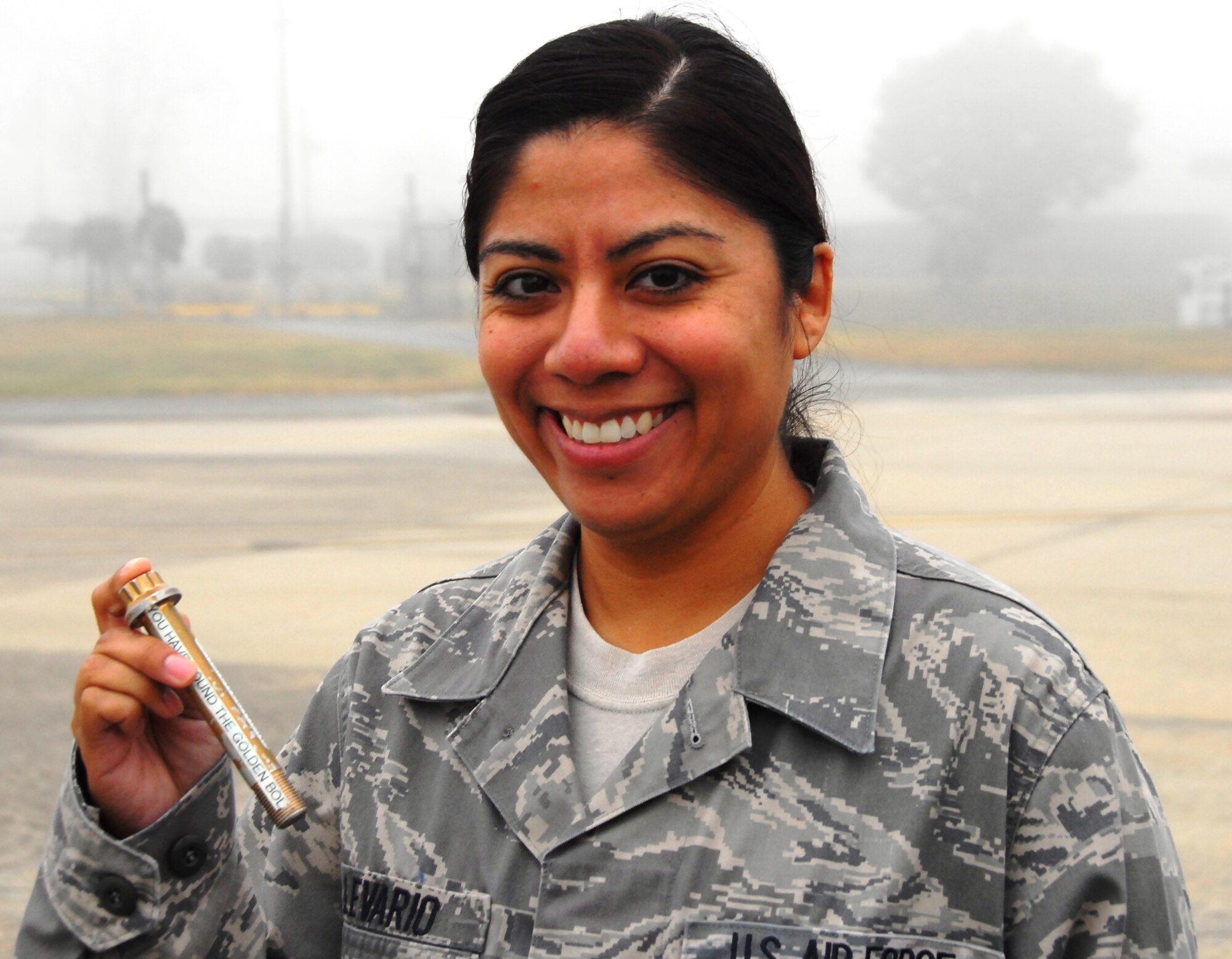 Staff Sgt. Jazika Levario, 51st Fighter Wing Legal, was one of five observant searchers during the foreign object walk Oct. 11 2011. For finding the "golden bolt" she received a 24-hour pass and a coin from the 51st FW vice commander. A wing-wide FOD walk was conducted following construction on the Osan Air Base airfield. (Air Force Photo by Senior Master Sgt. Stuart Camp)