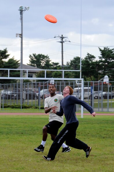 MISAWA AIR BASE, Japan - Members of the 35th Operations Group compete against members of the 35th Security Forces Squadron in a game of ultimate frisbee during the wing sports day here Oct. 7. The 35th Fighter Wing held a sports day to promote physical fitness, teamwork, competition, sportsmanship and esprit de corps. The day was kicked off with a 3-mile run followed by various sporting events to include relay races, basketball, softball, ultimate frisbee, soccer and a readiness competition. Approximately 14 units from the base formed teams to participate in each event. (U.S. Air Force photo/Tech. Sgt. Marie Brown)