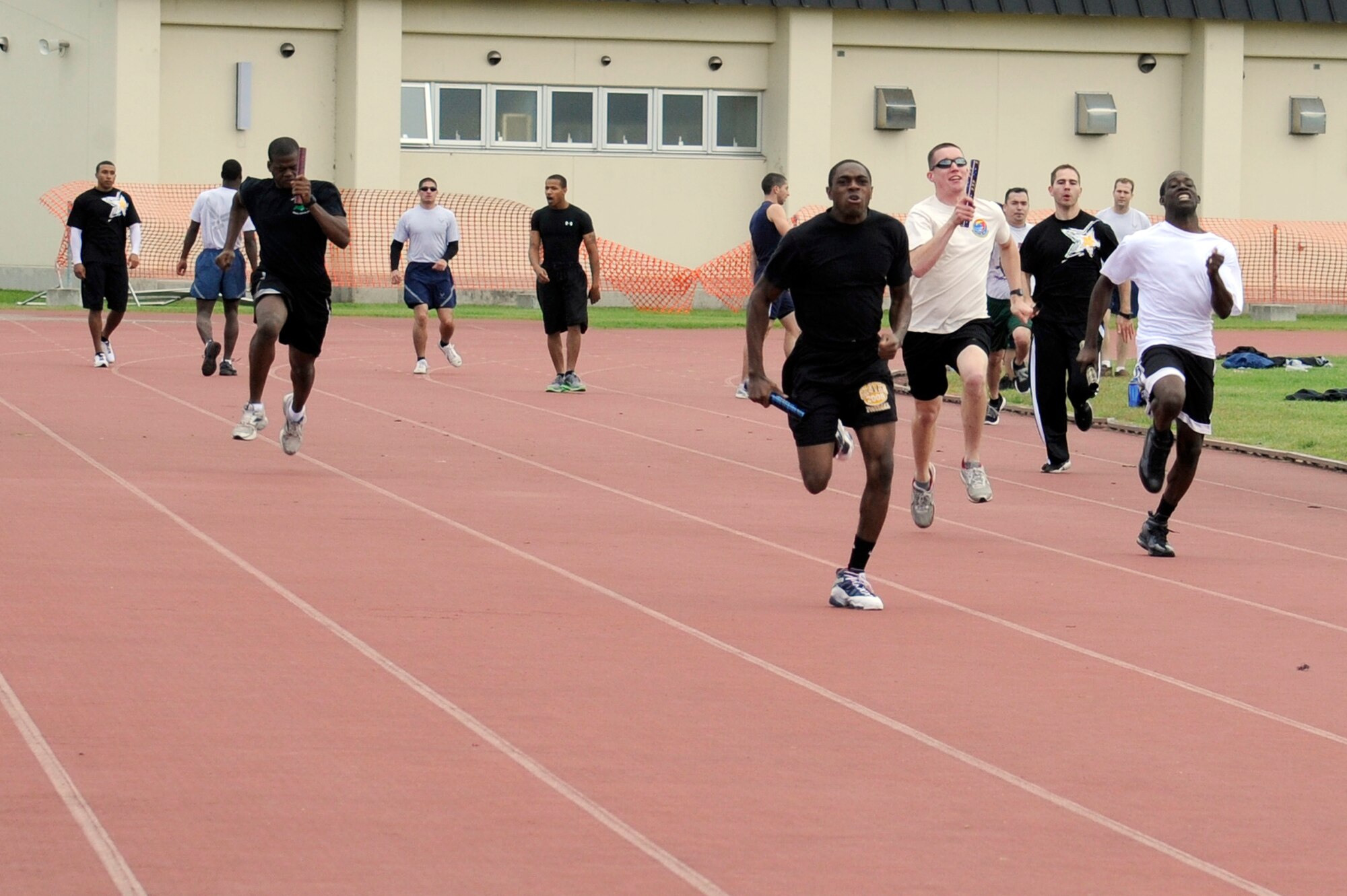 MISAWA AIR BASE, Japan - Approximately 14 teams compete in a 4x100 relay race during the wing sports day here Oct. 7. The 35th Fighter Wing held a sports day to promote physical fitness, teamwork, competition, sportsmanship and esprit de corps. The day was kicked off with a 3-mile run followed by various sporting events to include relay races, basketball, softball, ultimate frisbee, soccer and a readiness competition. Approximately 14 units from the base formed teams to participate in each event. (U.S. Air Force photo/Tech. Sgt. Marie Brown)