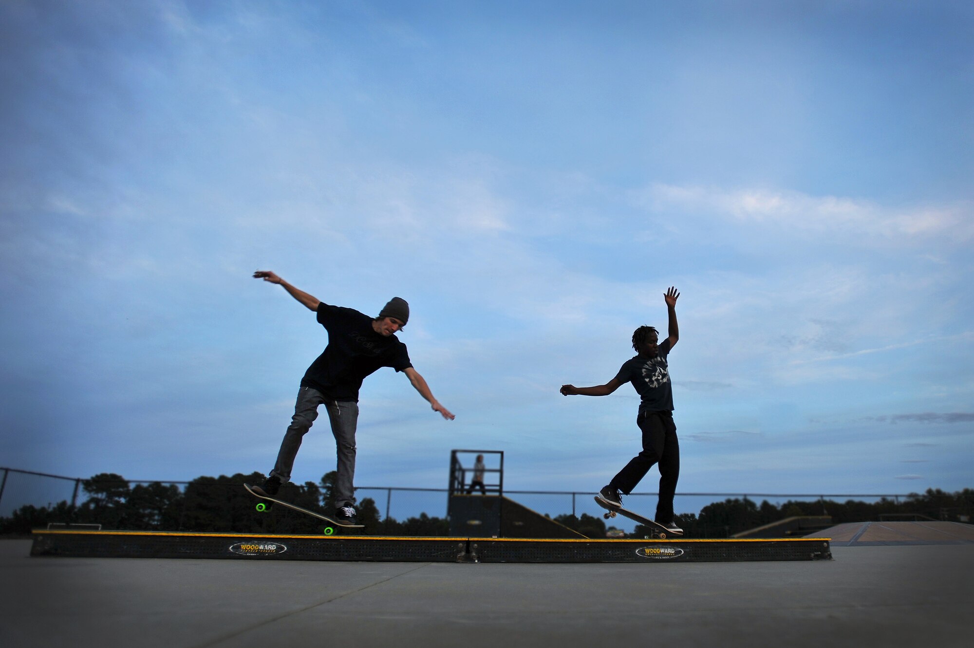 Devon Hornby, (left) and Patrick Kelly execute nose manuals as the last little bit of daylight slips away after a long day skating at the Sumter-Shaw Skate Park, Oct. 8, 2011, Sumter, S.C The Sumter-Shaw Skate Park offers an alternative to military and civilian youth skating on the streets and provides them a safe environment to increase their skills to do what they love. (U.S. Air Force photo by Senior Airman Kenny Holston/Released)


