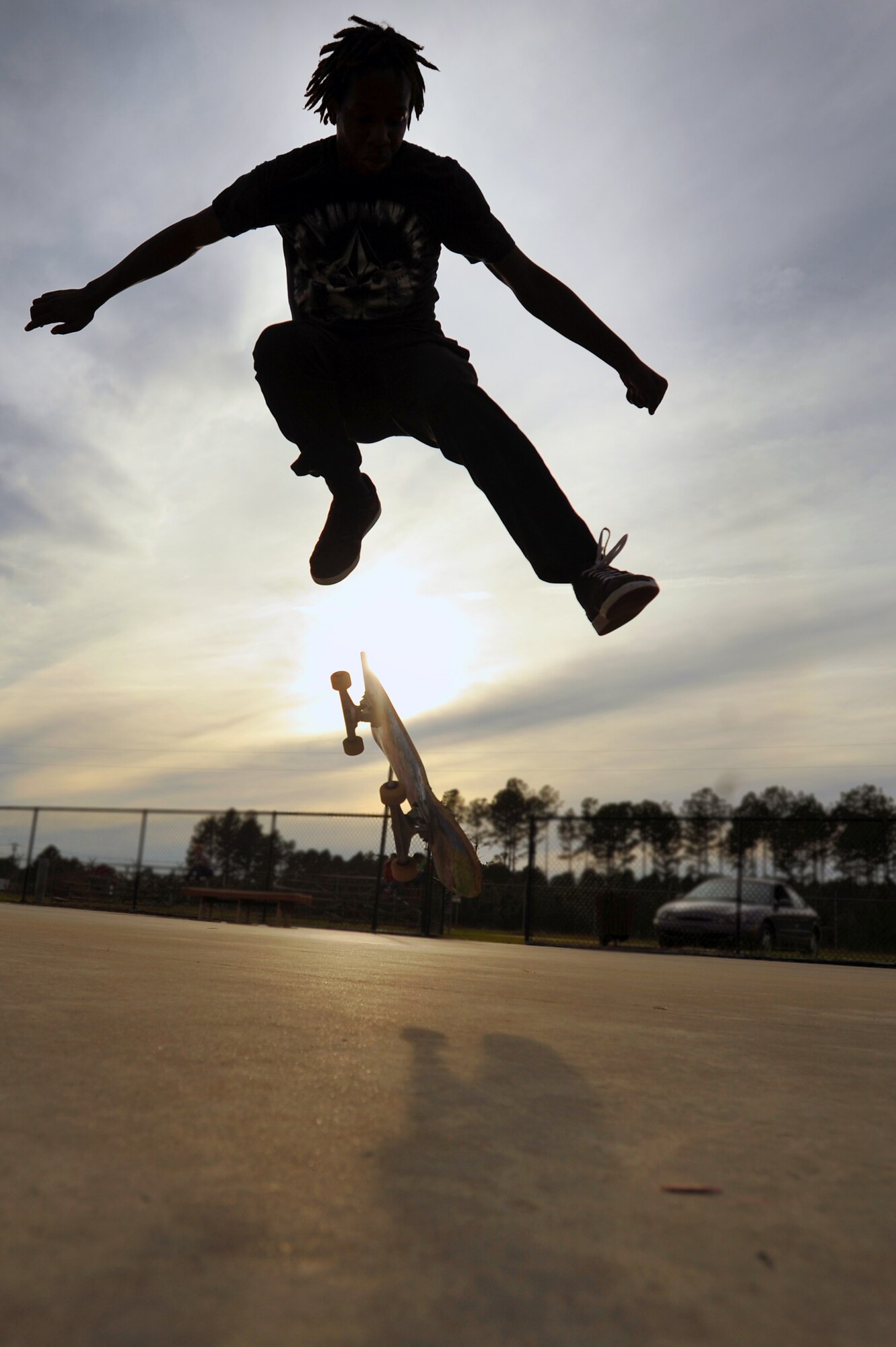 Patrick Kelly, silhouetted by the sun as it begins to set, finishes up a long day of skating at the Sumter-Shaw Skate Park, Oct. 8, 2011, Sumter, S.C. The Sumter-Shaw Skate Park offers an alternative to military and civilian youth skating on the streets and provides them a safe environment to increase their skills to do what they love. (U.S. Air Force photo by Senior Airman Kenny Holston/Released)


