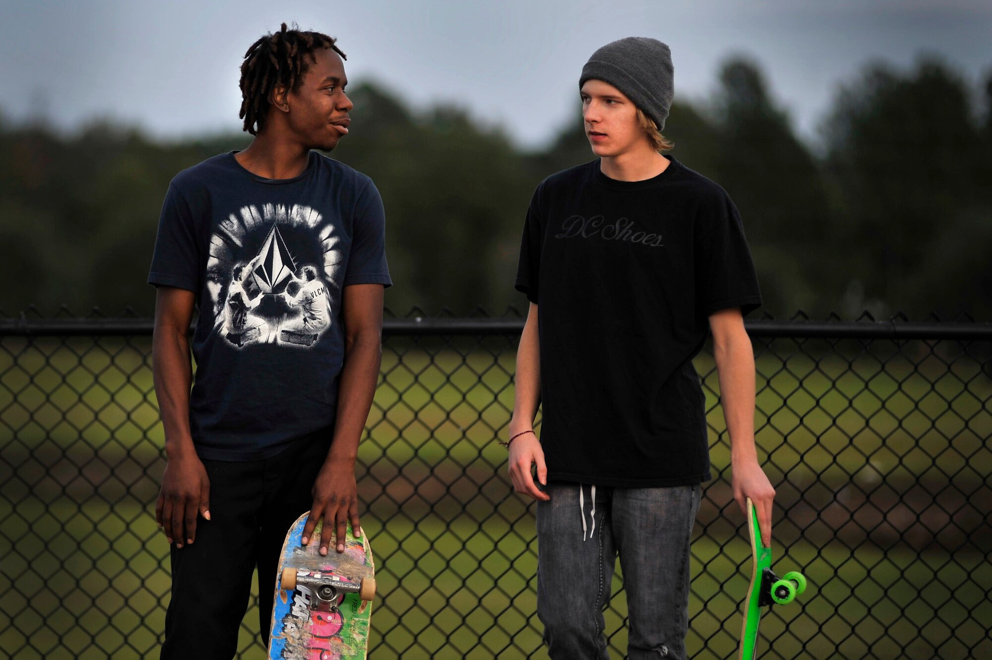 Patrick Kelly, (left) and Devon Hornby, stand inside the gates of the Sumter-Shaw Skate Park as they prepare to skate the rails and ramps that the park has to offer, Oct. 8, 2011, Sumter, S.C. The Sumter-Shaw Skate Park offers an alternative to military and civilian youth skating on the streets and provides them a safe environment to increase their skills to do what they love. (U.S. Air Force photo by Senior Airman Kenny Holston/Released)



