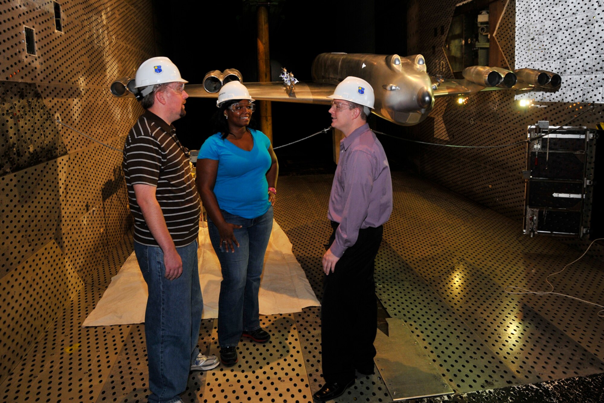 Paul Haas, B-52 Program Office, Tinker AFB, Druana Sanders, Booz-Allen & Hamilton, Inc, and Don Arrowood, B-52 Program Office, Tinker AFB, discuss the testing of the B-52H model in AEDC’s 16T between store separation test runs. (Photo by Rick Goodfriend)