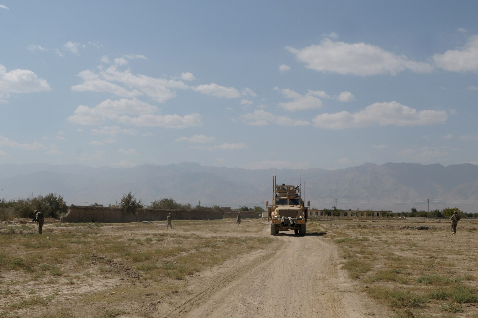 BAGRAM AIRFIELD, Afghanistan -- Members of the 455th Expeditionary Security Forces Squadron Quick Response Team, conduct a dismounted patrol outside the wire Sept. 26, 2011. The QRT searches for and deters enemy activity, denies enemy freedom of movement, provides a presence to establish rapport with local villagers, and collects reconnaissance for possible weapons caches and signs of staging an attack on the base. (U.S. Air Force photo/Senior Airman Krista Rose)