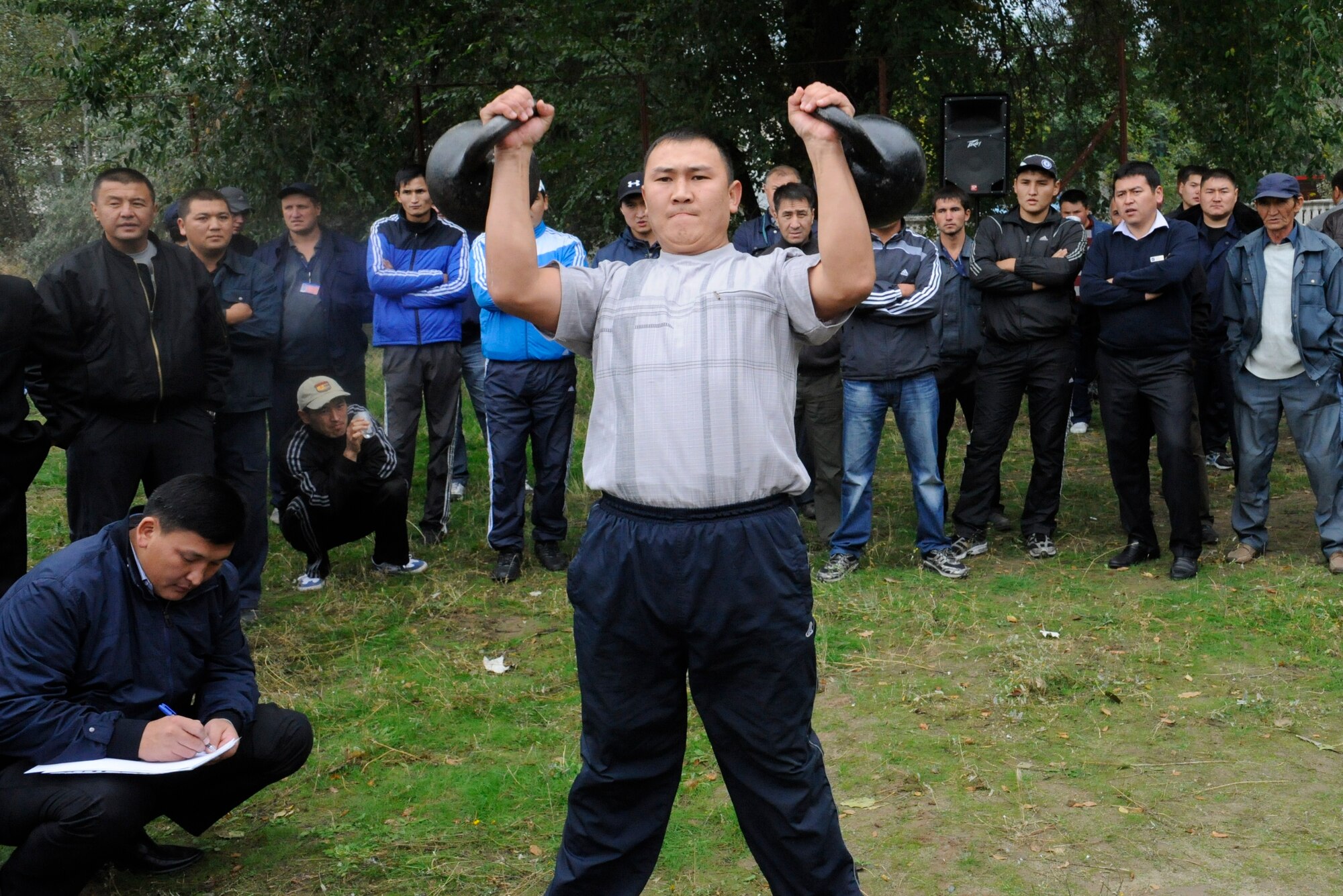 A Manas International Airport employee participates in a weightlifting competition at the Transit Center at Manas, Kyrgyzstan, Oct. 7. The event was part of a sports competition commemorating the 78th Anniversary of General Aviation in the Kyrgyz Republic. Airmen from the Transit Center and MIA employees participate in monthly sports competitions. (U.S. Air Force photo/Staff Sgt. Patrick Maciejewski)