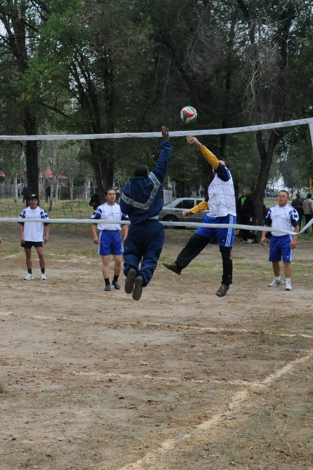 An Airman blocks a spike during a volleyball game against Manas International Airport employees at the Transit Center at Manas, Kyrgyzstan, Oct. 7. The game was part of a sports competition commemorating the 78th Anniversary of General Aviation in the Kyrgyz Republic. More than 270 people participated in the celebration. (U.S. Air Force photo/Staff Sgt. Patrick Maciejewski)