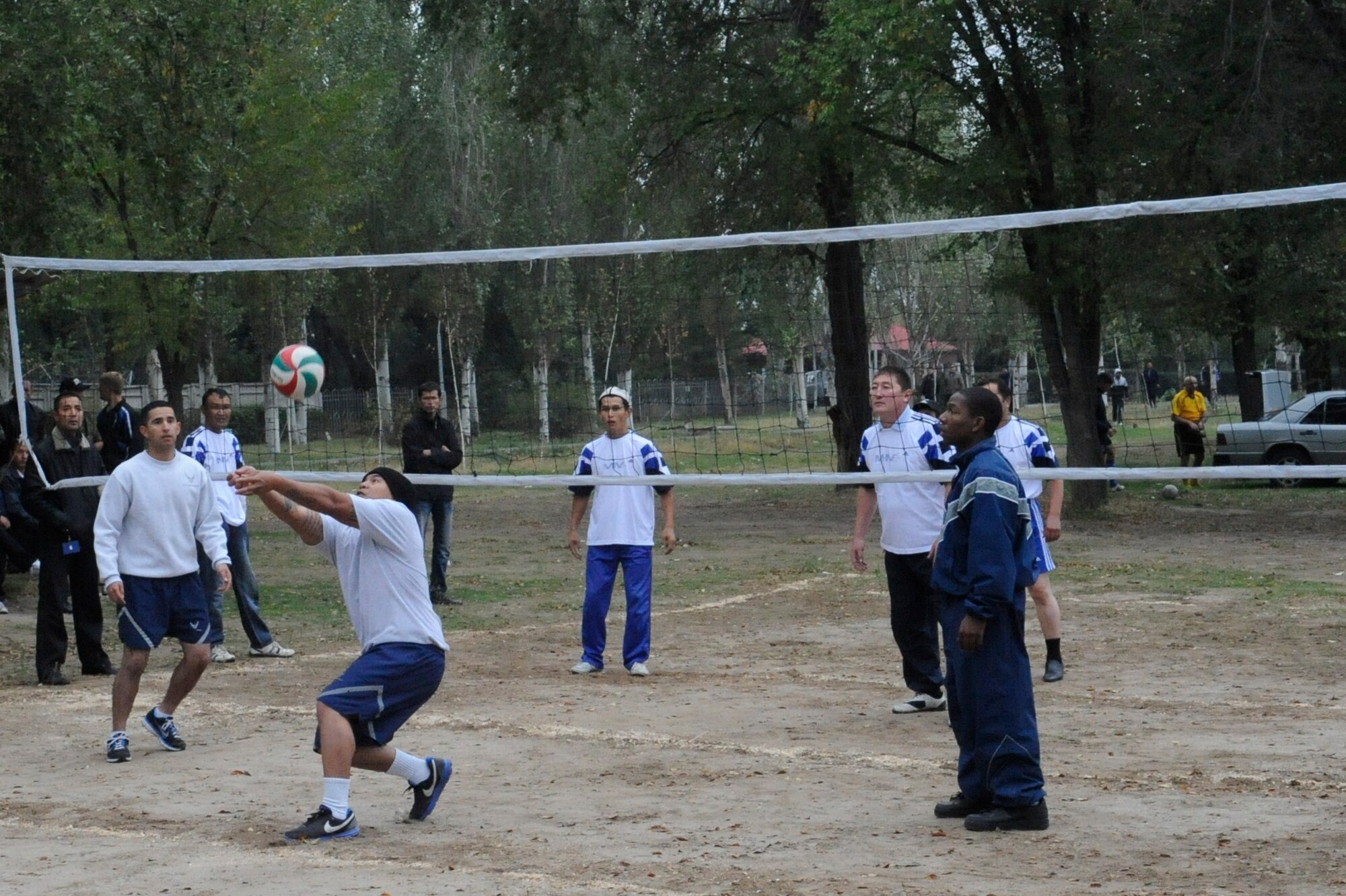 An Airman returns a serve during a volleyball game against Manas International Airport employees at the Transit Center at Manas, Kyrgyzstan, Oct. 7. The game was part of a sports competition commemorating the 78th Anniversary of General Aviation in the Kyrgyz Republic. More than 270 people participated in the celebration. (U.S. Air Force photo/Staff Sgt. Patrick Maciejewski)