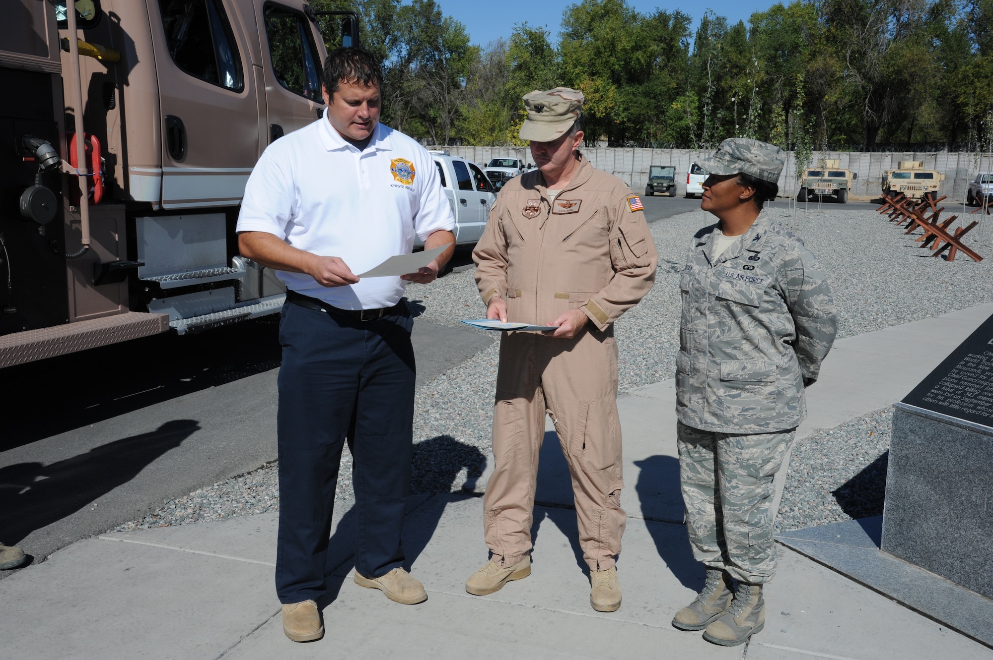 Fire Chief George Parker reads a proclamation initiating Fire Prevention Week as Col. Dave Pond and Col. Shawna O’Brien look on at the Transit Center at Manas, Kyrgyzstan, Oct. 9. Pond is the 376th Air Expeditionary Wing vice commander and O’Brien is the 376th Expeditionary Mission Support Group commander. (U.S. Air Force photo/Tech. Sgt. Hank Hoegen)