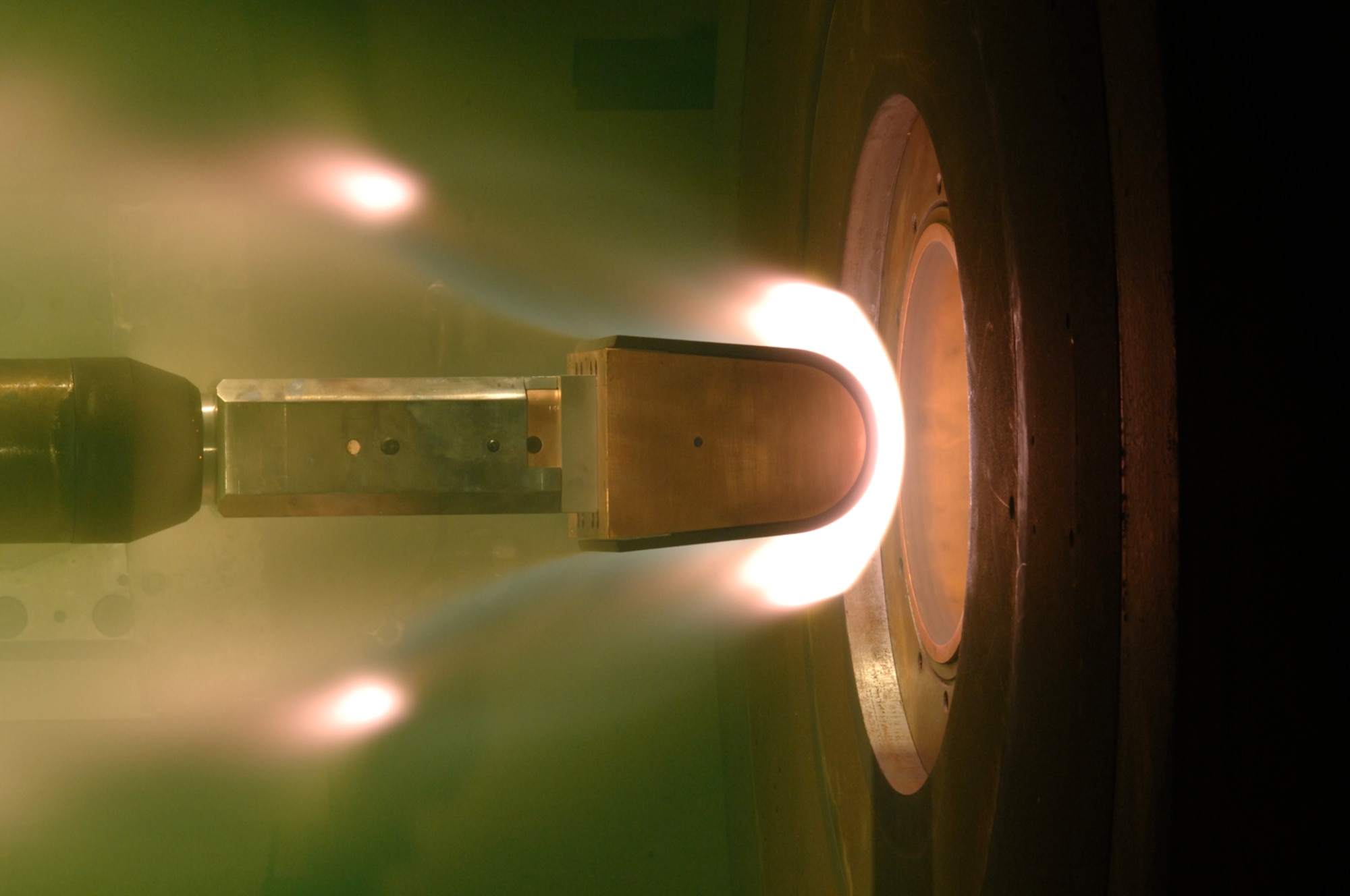 Pictured here are carbon-carbon leading edges under test in the 24-inch diameter nozzle in Arc Heater H-2 for the HTV-3 technology program during 2007. This is representative of the type of testing H-2 would conduct, but with the new mid-range capability, it would be possible to simulate higher enthalpies at mid-altitude shear conditions and longer run times, like those experienced by long-range global strike vehicles (AEDC file photo)
