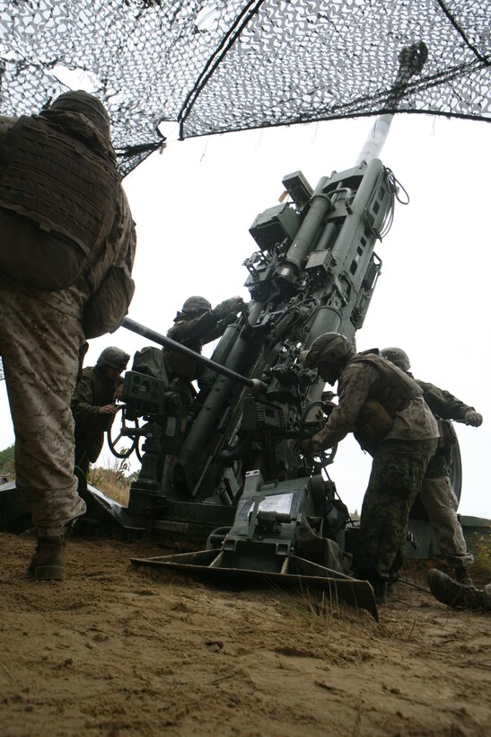 Marines with gun 3, Battery A, 1st Battalion, 10th Marine Regiment, 2nd Marine Division, prepare to fire an artillery round aboard Army Base Fort Bragg, N.C. Rolling Thunder is a training exercise where the Marines of 10th Marine Regiment fine tune their artillery skills.