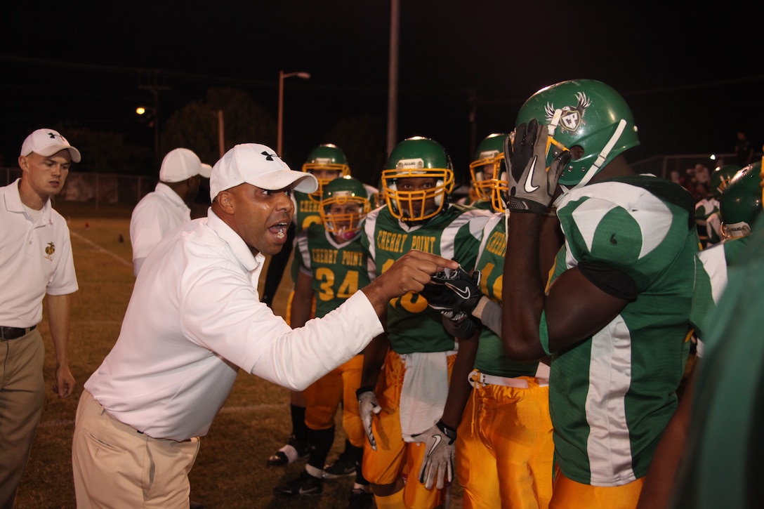 Lederrick G. Hunter, head coach for the Cherry Point Eagles, gets his team motivated and pumped up before the opening kickoff of the “battle of the air stations” football game between the Cherry Point Eagles and the New River Blue Knights at the Cherry Point Varsity Football Field Oct. 11.  Cherry Point edged out New River with a final score of 14-11. “We started slipping a bit toward the end but our defense really showed its resilience,” said Hunter. “We are going to go back to the drawing board and figure out ways to correct what needs to be corrected.”