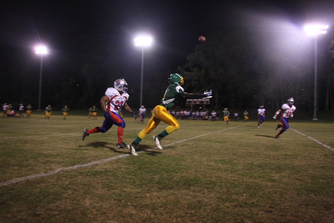 Jason Jarmond, a wide receiver for the Cherry Point Eagles, reaches for a pass thrown to him in stride during the “Battle of the Air Stations” football game between the Cherry Point Eagles and the New River Blue Knights at the Cherry Point Varsity Football Field Oct. 11.