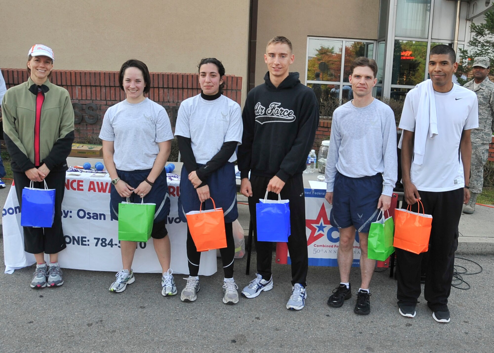 First, second and third in both the men and female categories for the Combined Federal Campaign 5K run pose for a photo after completing the run Oct. 7, 2011. The event had approximately 130 runners and raised $450. (U.S. Air Force photo/Senior Airman Adam Grant)      
