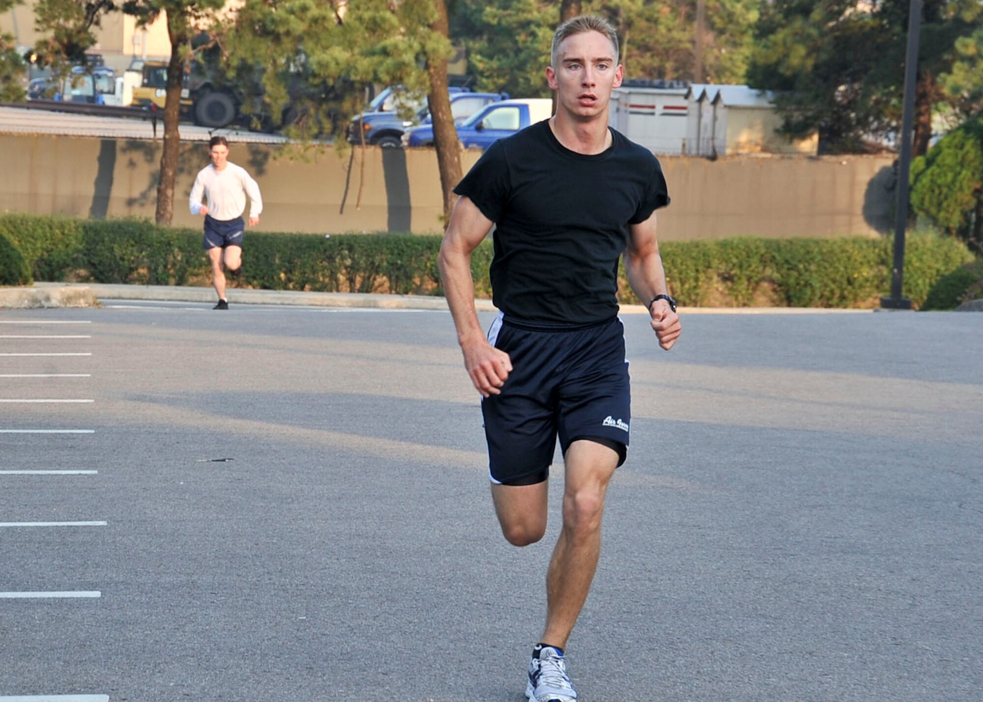 Senior Airman Michael Musiowski, 51st Communication Squadron cyber transport technician, rushes to the finish line first during the Combined Federal Campaign 5k run with a time of 18:23  Oct. 7, 2011. This is the 50th year anniversary for the CFC, which raises money for more than 2,400 charitable organizations. (U.S. Air Force photo/Senior Airman Adam Grant)     

