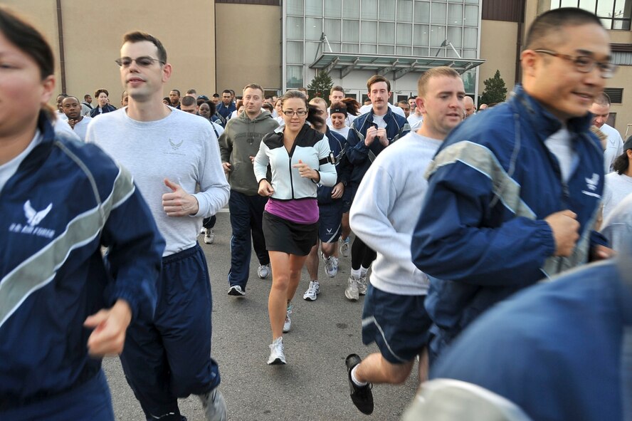 Runners participating in the Combined Federal Campaign 5k run sprint from the starting line Oct. 7, 2011. This year is the 50th anniversary for the CFC, which raises money for more than 2,400 charitable organizations. (U.S. Air Force photo/Senior Airman Adam Grant)     