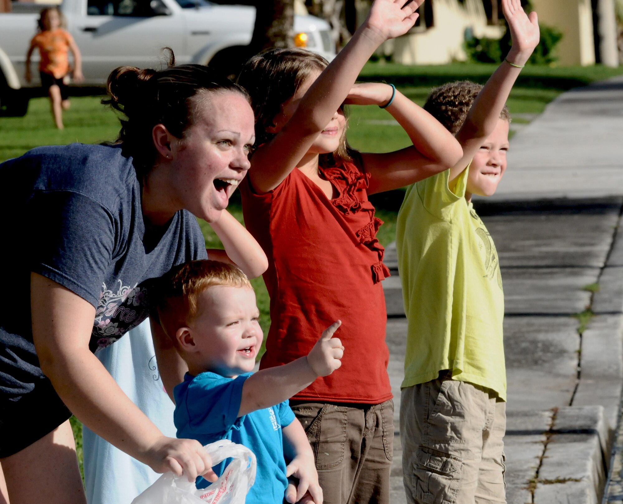 ANDERSEN AIR FORCE BASE, Guam—Members of the Andersen community wave as the Fire Prevention Week parade travels through housing here, Oct. 8. Andersen’s theme this year for Fire Prevention week is “Protect Your Family from Fire,” and the Andersen Fire and Emergency flight will be having events from Oct. 9-15 to educate base personnel on fire safety. (U.S. Air Force photo by Senior Airman Benjamin Wiseman/Released)