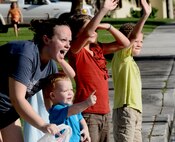 ANDERSEN AIR FORCE BASE, Guam—Members of the Andersen community wave as the Fire Prevention Week parade travels through housing here, Oct. 8. Andersen’s theme this year for Fire Prevention week is “Protect Your Family from Fire,” and the Andersen Fire and Emergency flight will be having events from Oct. 9-15 to educate base personnel on fire safety. (U.S. Air Force photo by Senior Airman Benjamin Wiseman/Released)