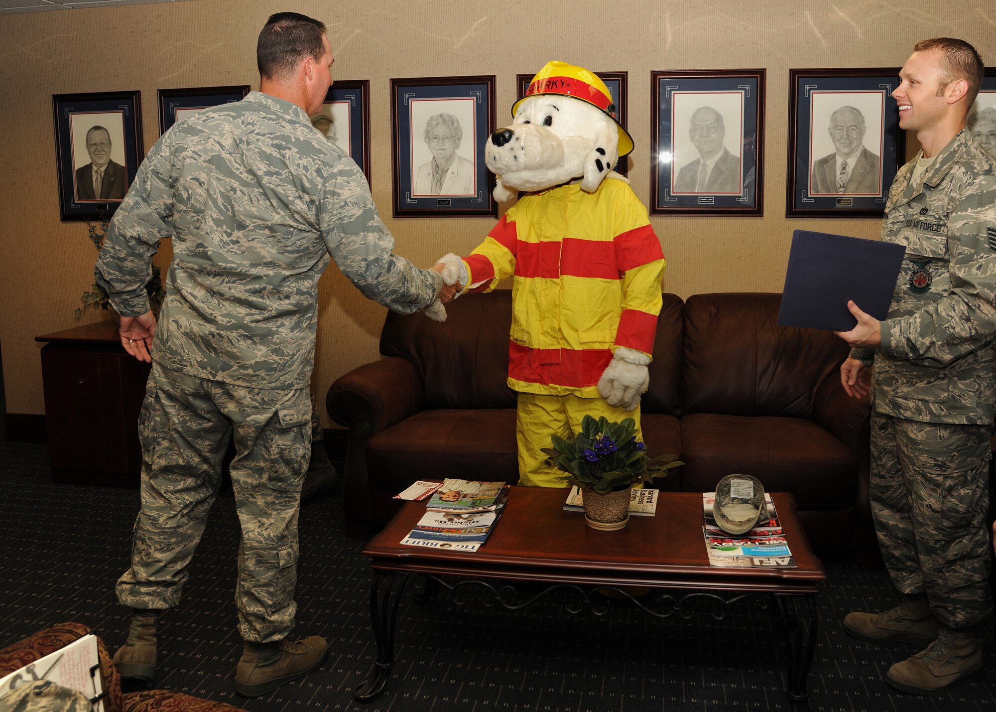 Col. Tim Bush, 319th Air Base Wing commander, shakes hands with Sparky the Fire Dog – the fire safety advocate and spokesdog for the National Fire Protection Association - on Oct. 11 at Grand Forks Air Force Base, North Dakota.  Col. Bush signed the 2011 Fire Prevention Week Proclamation effective Oct. 9 to Oct. 15, ensuring the safety and security of all those living, working and visiting the base.  This year’s theme is “Protect Your Family from Fire” to help lower the annual average of approximately 3,000 lost lives due to fire incidents. (U.S. Air Force photo by Airman 1st Class Ashley N. Taylor)
