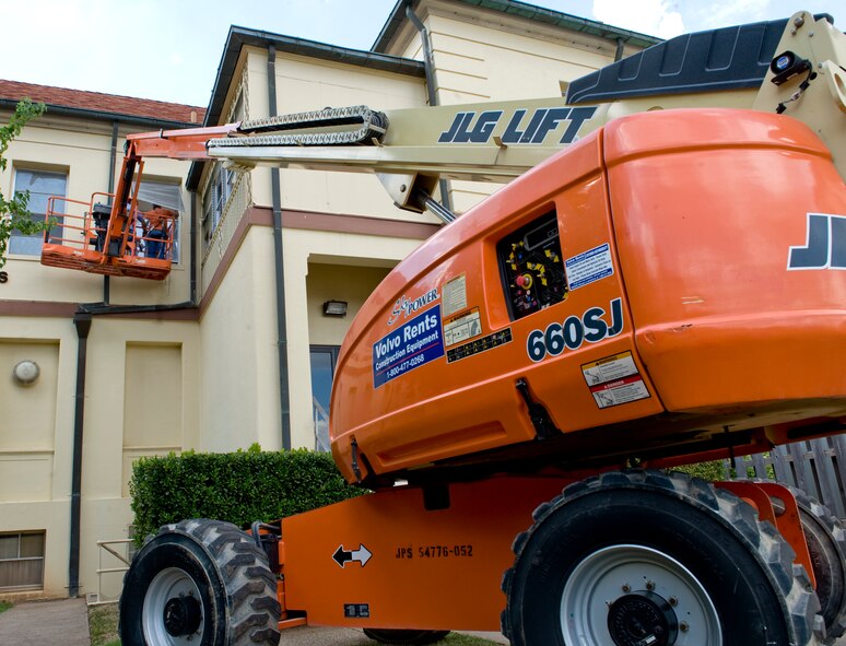 Contracted workers tint windows above the Dougherty Conference Center on Barksdale Air Force Base, La., Oct. 11. The windows were tinted in order to prevent glass shattering in case of severe weather or an explosion. (U.S. Air Force photo/Airman 1st Class Benjamin Gonsier)(RELEASED)